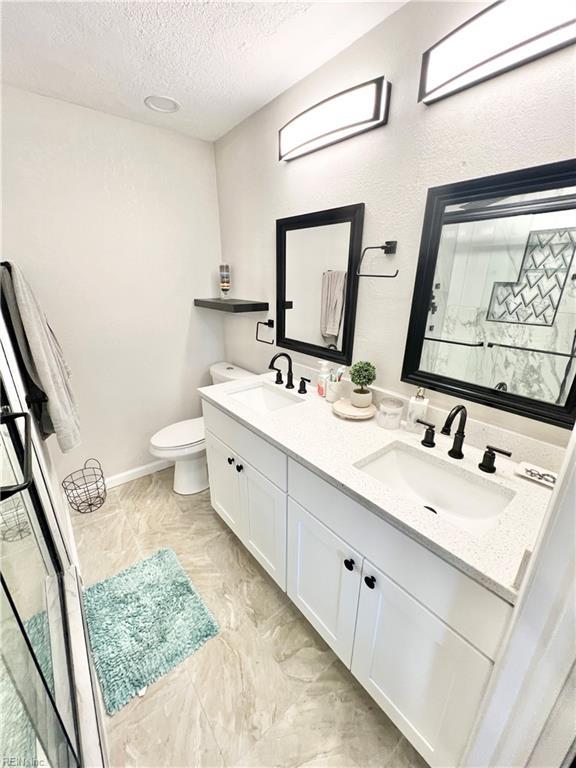 969 Westerly Trl, Virginia Beach, VA 23464 - full bathroom featuring a textured ceiling, double vanity, and an enclosed shower