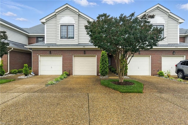 106 Genoa Dr, Hampton, VA 23664 - view of front of home featuring a garage, concrete driveway, brick siding, and a shingled roof