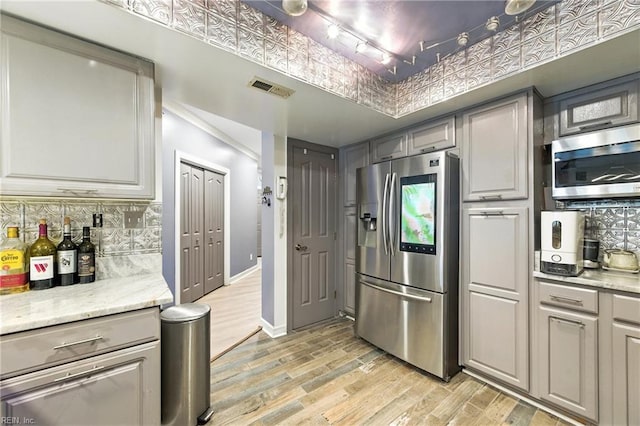 106 Genoa Dr, Hampton, VA 23664 - kitchen featuring appliances with stainless steel finishes, light wood-type flooring, tasteful backsplash, and gray cabinets