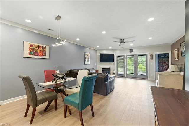 106 Genoa Dr, Hampton, VA 23664 - dining room with crown molding, recessed lighting, a ceiling fan, light wood-style flooring, and a glass covered fireplace