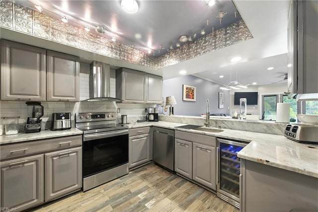 106 Genoa Dr, Hampton, VA 23664 - kitchen with stainless steel appliances, beverage cooler, wall chimney range hood, gray cabinets, and light wood finished floors