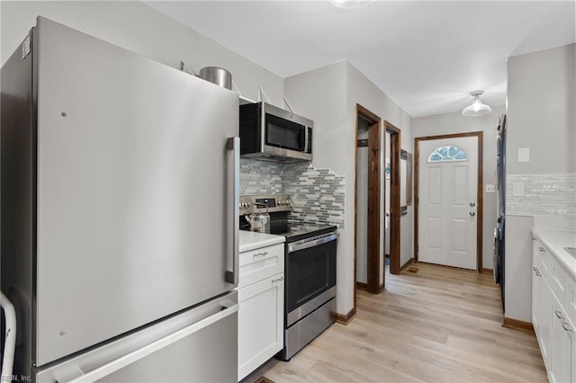 11855 Harcum Rd, Gloucester, VA 23061 - kitchen featuring appliances with stainless steel finishes, decorative backsplash, and white cabinets
