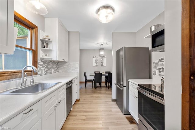 11855 Harcum Rd, Gloucester, VA 23061 - kitchen with appliances with stainless steel finishes, white cabinets, tasteful backsplash, and light countertops
