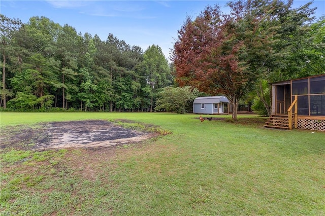 11855 Harcum Rd, Gloucester, VA 23061 - view of green lawn with a sunroom, a shed, and a forest view