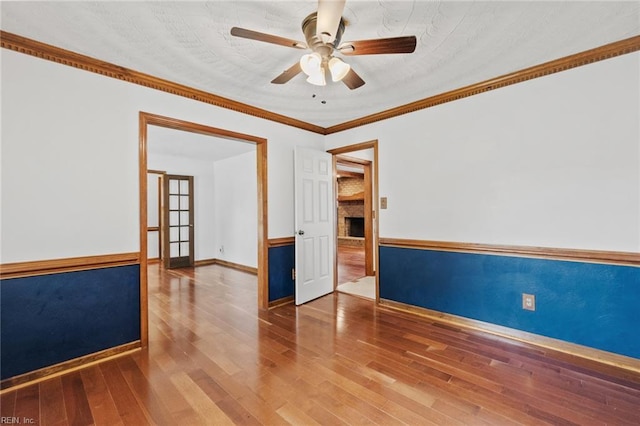 3419 Filly Run, Chesapeake, VA 23323 - empty room with a ceiling fan, a large fireplace, wood finished floors, and ornamental molding