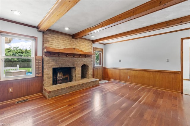 3419 Filly Run, Chesapeake, VA 23323 - unfurnished living room featuring beam ceiling, hardwood / wood-style floors, a fireplace, a wainscoted wall, and crown molding