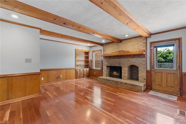 3419 Filly Run, Chesapeake, VA 23323 - unfurnished living room with beam ceiling, a fireplace, hardwood / wood-style floors, wainscoting, and wood walls