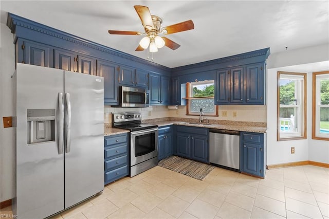 3419 Filly Run, Chesapeake, VA 23323 - kitchen with appliances with stainless steel finishes, blue cabinetry, a ceiling fan, backsplash, and light stone countertops