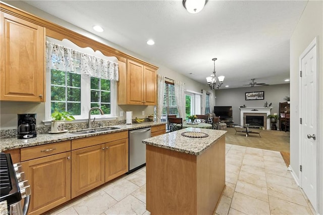 2152 Benomi Dr, Williamsburg, VA 23185 - kitchen with stainless steel dishwasher, a kitchen island, a ceiling fan, light stone counters, and healthy amount of natural light