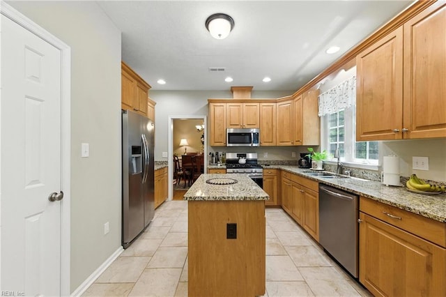 2152 Benomi Dr, Williamsburg, VA 23185 - kitchen featuring stainless steel appliances, a kitchen island, light stone countertops, light tile patterned floors, and recessed lighting