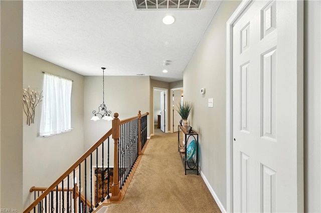 2152 Benomi Dr, Williamsburg, VA 23185 - corridor featuring a chandelier, light colored carpet, an upstairs landing, and recessed lighting