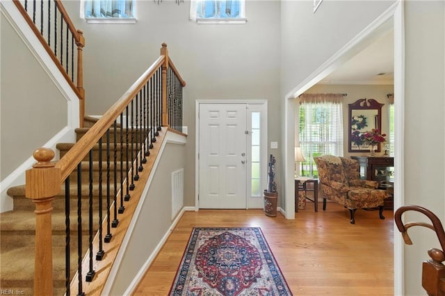 2152 Benomi Dr, Williamsburg, VA 23185 - entrance foyer with wood finished floors, crown molding, stairway, and a high ceiling