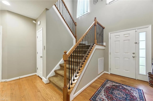 2152 Benomi Dr, Williamsburg, VA 23185 - entryway with wood finished floors, stairs, healthy amount of natural light, and a high ceiling