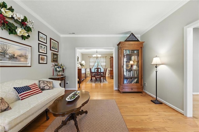 2152 Benomi Dr, Williamsburg, VA 23185 - living area featuring light wood-style flooring, a chandelier, and ornamental molding