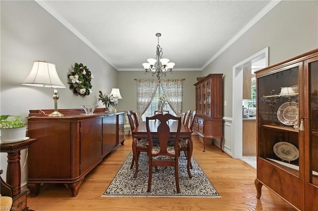 2152 Benomi Dr, Williamsburg, VA 23185 - dining area featuring a chandelier, light wood-style flooring, and ornamental molding