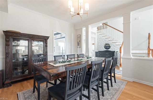 119 Grand View Dr, Hampton, VA 23664 - dining space with ornate columns, light wood-style floors, ornamental molding, stairway, and a chandelier