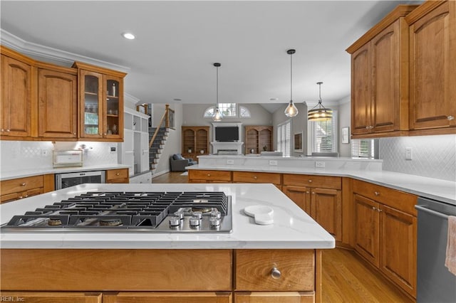 860 Greenfield Ln, Chesapeake, VA 23322 - kitchen with appliances with stainless steel finishes, light wood finished floors, brown cabinets, glass insert cabinets, and a peninsula