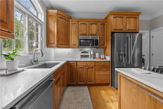 860 Greenfield Ln, Chesapeake, VA 23322 - kitchen featuring stainless steel appliances, ornamental molding, healthy amount of natural light, light countertops, and brown cabinetry