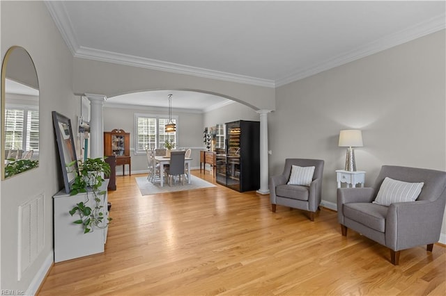 860 Greenfield Ln, Chesapeake, VA 23322 - sitting room featuring ornate columns, light wood-style floors, arched walkways, and ornamental molding
