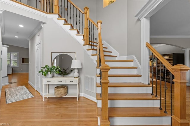 860 Greenfield Ln, Chesapeake, VA 23322 - staircase with ornamental molding, wood finished floors, arched walkways, decorative columns, and recessed lighting