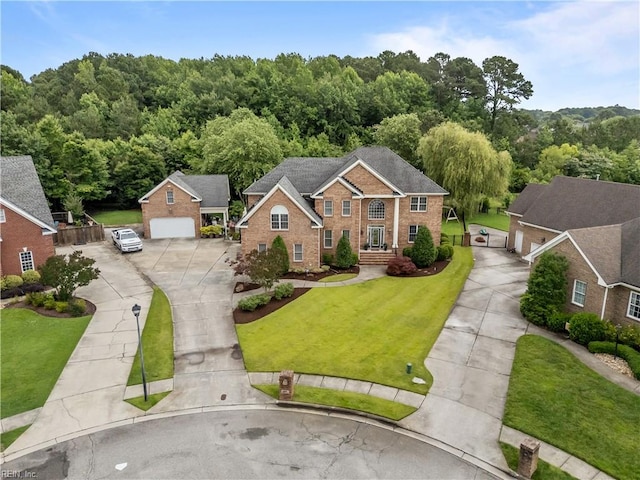 860 Greenfield Ln, Chesapeake, VA 23322 - view of front facade featuring driveway, brick siding, a front lawn, and a view of trees