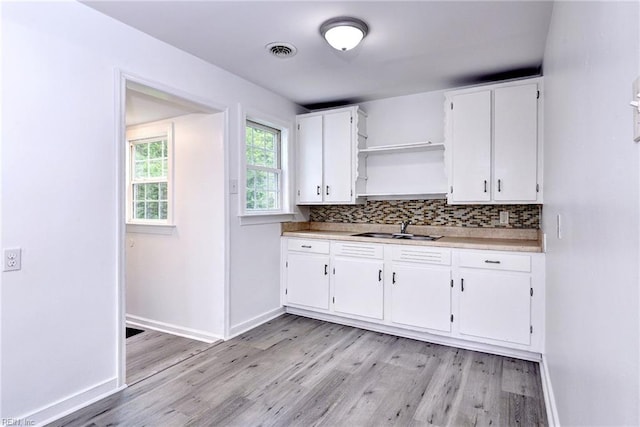 513 W Maynor Dr, Williamsburg, VA 23185 - kitchen featuring open shelves, light wood-type flooring, white cabinets, and tasteful backsplash