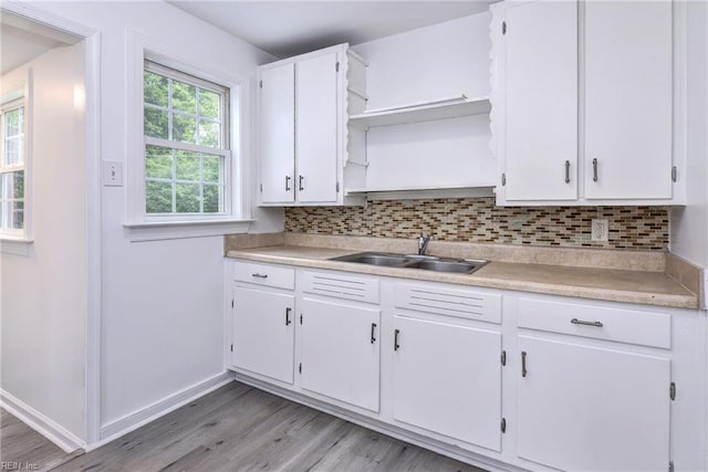 513 W Maynor Dr, Williamsburg, VA 23185 - kitchen featuring open shelves, light countertops, backsplash, light wood-style flooring, and white cabinetry