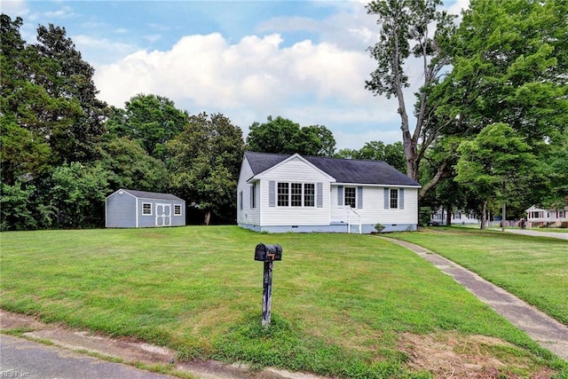 513 W Maynor Dr, Williamsburg, VA 23185 - view of front facade with crawl space, a storage unit, and a front lawn