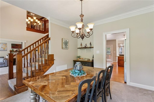 713 Tupelo Xing, Chesapeake, VA 23320 - dining space with a chandelier, crown molding, stairway, light wood-style flooring, and light colored carpet
