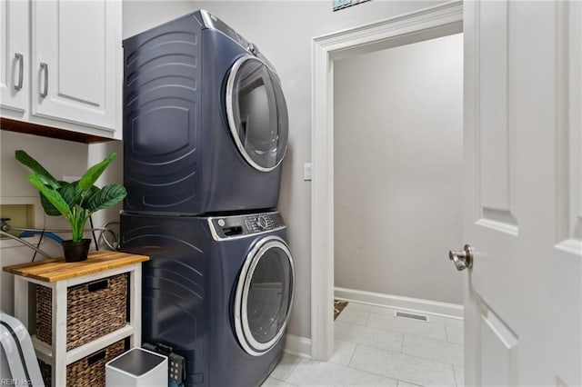 713 Tupelo Xing, Chesapeake, VA 23320 - laundry room with stacked washing machine and dryer, light tile patterned floors, and cabinet space