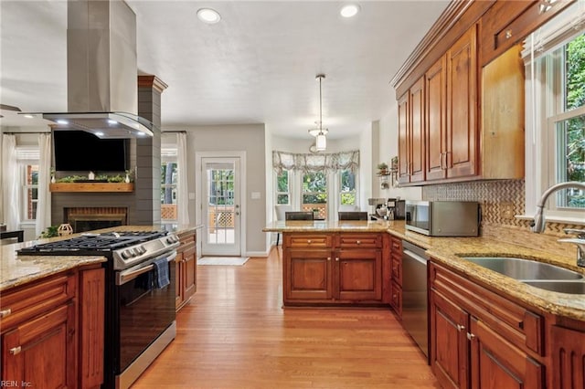 713 Tupelo Xing, Chesapeake, VA 23320 - kitchen featuring appliances with stainless steel finishes, island exhaust hood, light wood finished floors, plenty of natural light, and recessed lighting