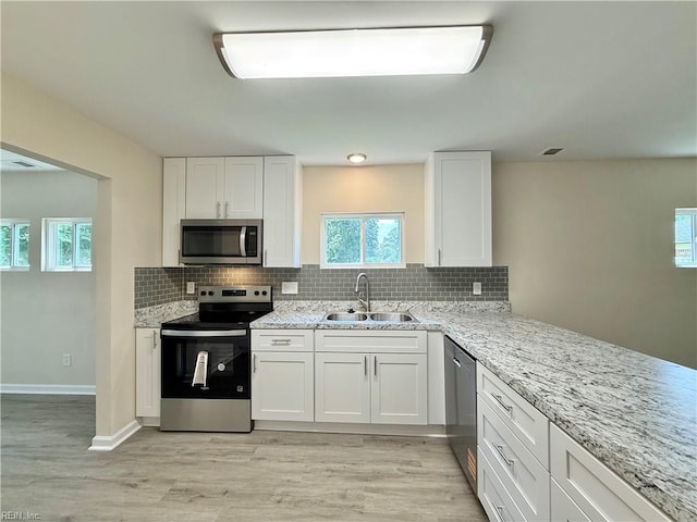 3909 Old Tree Ln, Virginia Beach, VA 23452 - kitchen featuring stainless steel appliances, white cabinetry, decorative backsplash, and light stone counters