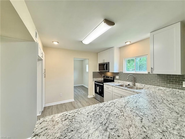 3909 Old Tree Ln, Virginia Beach, VA 23452 - kitchen with stainless steel appliances, light stone countertops, decorative backsplash, light wood-style flooring, and white cabinets