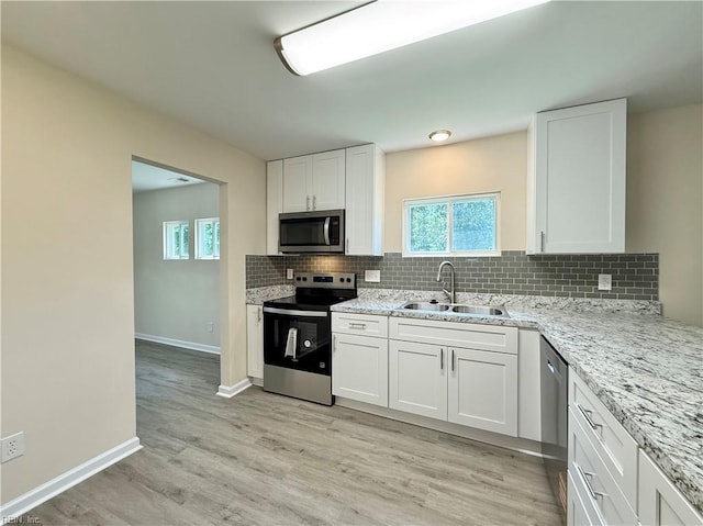 3909 Old Tree Ln, Virginia Beach, VA 23452 - kitchen with appliances with stainless steel finishes, decorative backsplash, plenty of natural light, and white cabinets