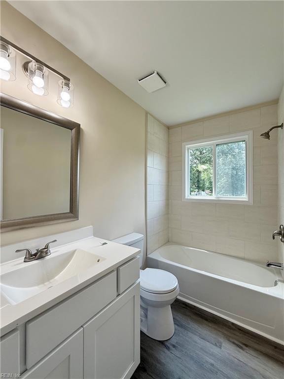 3909 Old Tree Ln, Virginia Beach, VA 23452 - full bathroom with vanity, wood finished floors, and washtub / shower combination