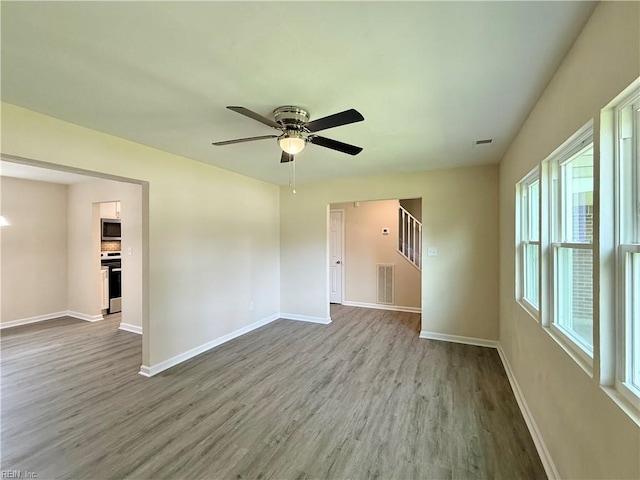 3909 Old Tree Ln, Virginia Beach, VA 23452 - empty room with wood finished floors, ceiling fan, and stairs