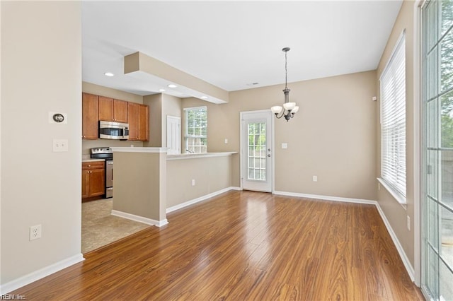 1439 Otterbourne Cir, Chesapeake, VA 23320 - unfurnished living room featuring light wood-style flooring, a chandelier, and recessed lighting