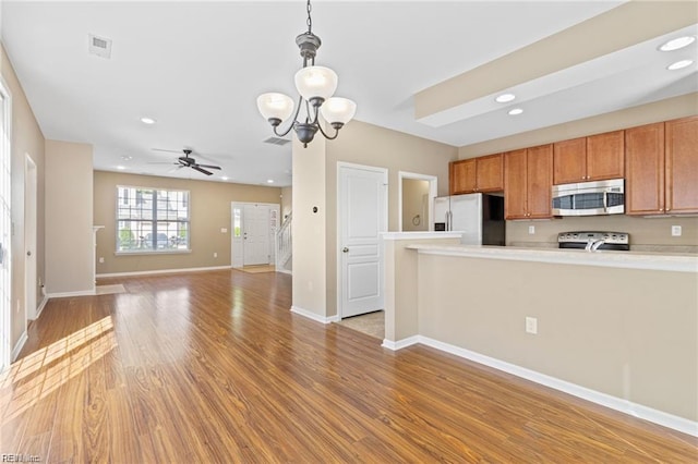 1439 Otterbourne Cir, Chesapeake, VA 23320 - kitchen with appliances with stainless steel finishes, a chandelier, light countertops, ceiling fan, and light wood-type flooring