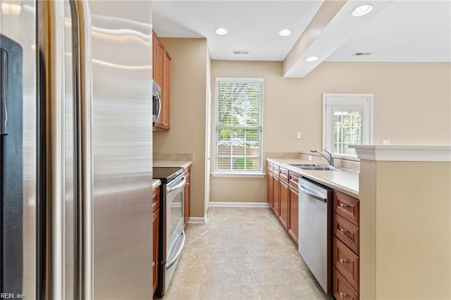 1439 Otterbourne Cir, Chesapeake, VA 23320 - kitchen with stainless steel appliances, light countertops, brown cabinets, recessed lighting, and a peninsula