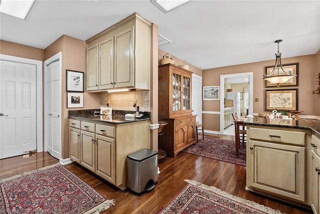 525 Pagan Rd, Smithfield, VA 23430 - kitchen with dark wood-style floors, tasteful backsplash, hanging light fixtures, and dark stone countertops