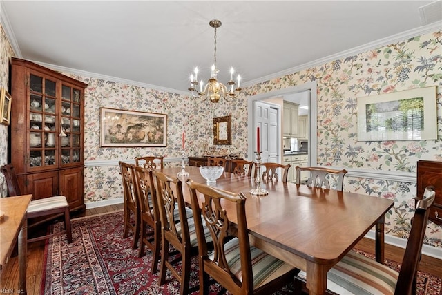 525 Pagan Rd, Smithfield, VA 23430 - dining room with wallpapered walls, a chandelier, dark wood finished floors, and crown molding