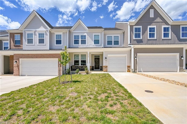 2207 Fallon Cir, Williamsburg, VA 23188 - multi unit property featuring a garage, concrete driveway, a front yard, and board and batten siding