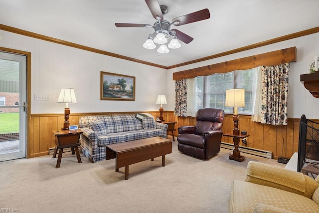 32391 S Main St, Boykins, VA 23827 - carpeted living room with baseboard heating, wood walls, a ceiling fan, ornamental molding, and a wainscoted wall