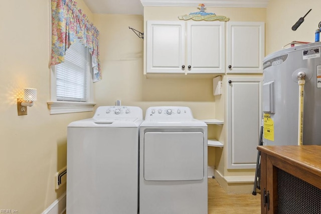 32391 S Main St, Boykins, VA 23827 - laundry area with washing machine and clothes dryer, cabinet space, electric water heater, and light wood finished floors