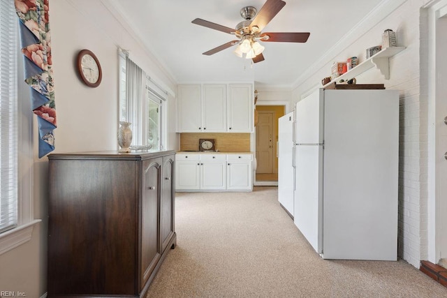 32391 S Main St, Boykins, VA 23827 - kitchen featuring freestanding refrigerator, light colored carpet, plenty of natural light, and ornamental molding