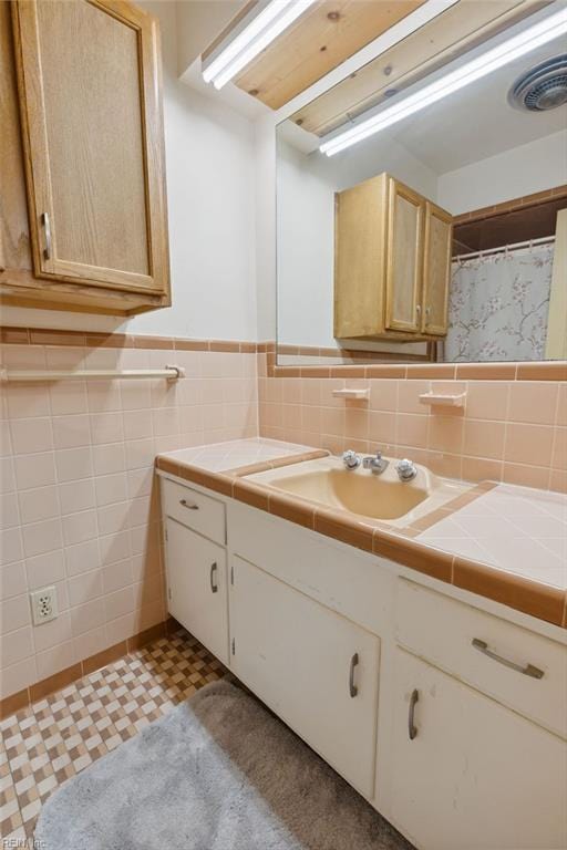 32391 S Main St, Boykins, VA 23827 - bathroom featuring tile walls, vanity, and a wainscoted wall