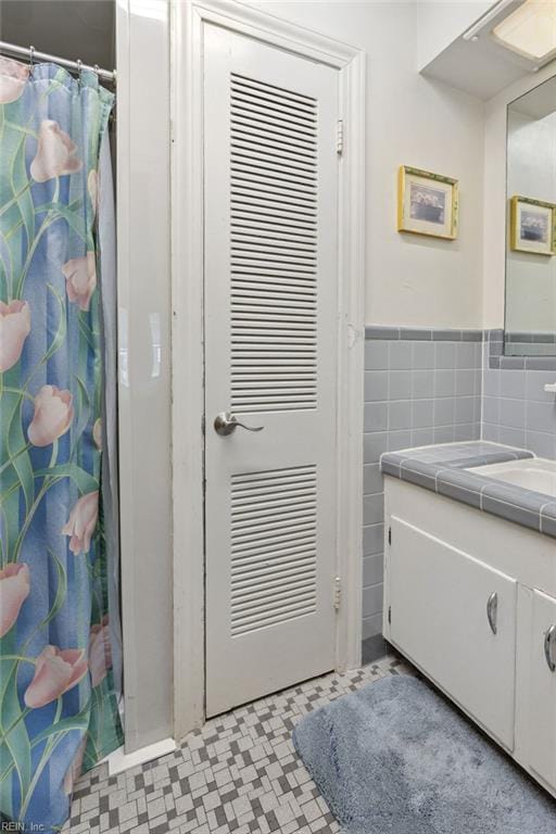32391 S Main St, Boykins, VA 23827 - full bathroom featuring vanity, tile patterned floors, a shower with curtain, and wainscoting