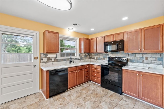 2655 Village Ave, Chesapeake, VA 23323 - kitchen with black appliances, tasteful backsplash, brown cabinets, and recessed lighting