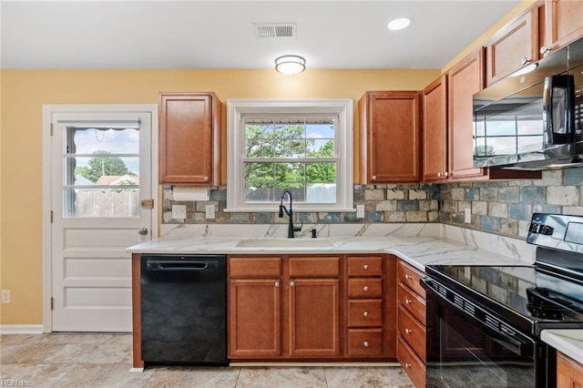 2655 Village Ave, Chesapeake, VA 23323 - kitchen featuring black appliances, backsplash, brown cabinetry, and light stone counters