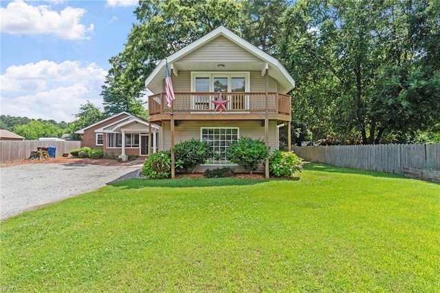 2655 Village Ave, Chesapeake, VA 23323 - view of front of house with a balcony, a fenced backyard, and gravel driveway
